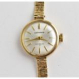 A vintage ladies 9ct gold cased manual wind Garrard wristwatch having a silvered dial with baton