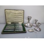 Mixed silver to include three weighted candlesticks, cased silver handle knifes and a decanter label