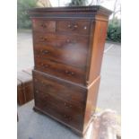 A George III mahogany chest on chest having a dentil moulded cornice, two short and six long drawers