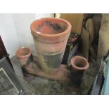 A large terracotta three breast chimney pot 75cm h x 75cm w