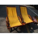 A pair of teak framed deck chairs Location: