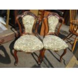 A pair of late 19th century French walnut side chairs having carved top rails and on front