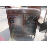 An early 20th century mahogany two door glazed display cabinet having three loose shelves,