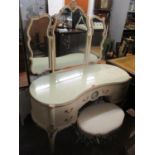 A vintage French style dressing table having a trifold mirror, five drawers and on cabriole legs,