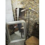 A modern silver coloured wall mirror with bevelled glass together with a chrome trouser press and