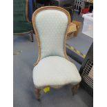 A Victorian walnut spoon back salon chair on front cabriole legs