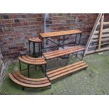 Garden plant pot stands with wooden slats and metal frames Location: