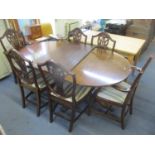 A reproduction mahogany extending dining table with extra leaf, together with a set of six shield