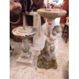 A garden stoneware bird bath in the form of a boy, 82cm h x 30cm w, together with a sundial on a