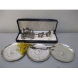 Three silver pin dishes together with a silver propelling pencil and a white metal ornament of a