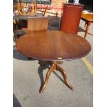 A vintage Ercol elm stained dining table with extra leaf and on four legs, 71.5cm h x 111cm w