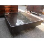 A modern glass topped and leather square framed coffee table, 26cm h x 84.5cm w Location: