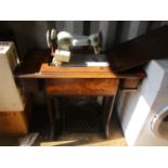 An early 20th century oak Singer treadle table fitted with a later Norum sewing machine Location: