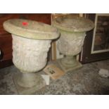 A pair of weathered garden concrete pedestal planters of urn shape, decorated in the classical taste