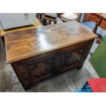 An early 20th century and earlier oak cabinet with twin doors, enclosing two drawers 83cm h x