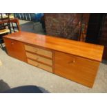 A 1960s teak sideboard, three long drawers flanked by cupboards A/F 46cm h x 18cm w Location: