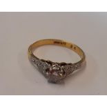 An 18ct gold and diamond ring with a platinum setting, ring size UK P, total weight 2.8g Location: