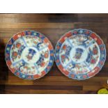 A pair of early 20th century Japanese Imari chargers decorated with panels, 40cm diameter Location: