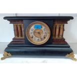 A late 19th/early 20th century treen painted architectural design mantel clock fitted with an