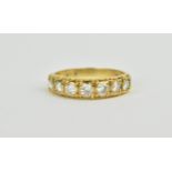 A yellow gold and diamond half eternity ring, the 7 brilliant cut diamonds around 1.2 carat in