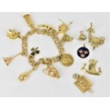 A 14ct yellow gold charm bracelet with multiple charms to include a 1910 Indian Head American 2 1/