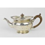A George V silver teapot by William Neale, Birmingham 1922, the top with gadrooned and shell border,