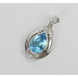 An 18ct white gold, diamond and blue gemstone (aquamarine or topaz) pendant, the central pear cut