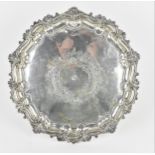 An Edwardian silver salver by Walker & Hall, Sheffield 1902, of circular shape with shell, scroll