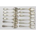 A set of twelve sterling silver tea spoons, possibly American, with extensively ornate handles