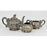A late 19th century Chinese Export silver three piece tea set, probably Canton, comprising a teapot,