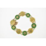 A Chinese yellow metal and green jade bracelet, with five green jade bi discs with yellow metal