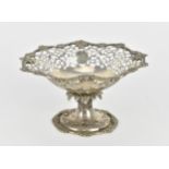 An Edwardian silver footed bonbon dish, with scalloped, floral rim and pierced scroll border