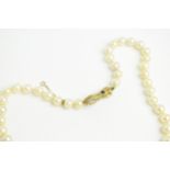 A pearl necklace with a Victorian diamond and sapphire encrusted gold hand clasp and safety chain,