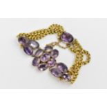A Victorian yellow metal and amethyst bracelet set with oval-shape clustered amethysts in gold