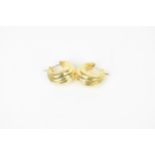 A pair of yellow metal hoop earrings, of fluted design, 2.2 cm long, weight 4 grams, test as gold