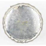 A late Victorian silver salver by Charles Stuart Harris, London 1892, of scalloped form with