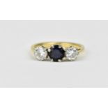 An 18ct yellow gold, platinum, diamond and sapphire three stone ring, the central sapphire held in