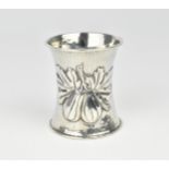An Edwardian silver napkin ring by Omar Ramsden, London 1910, of waisted form with embossed figs and