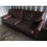 A large brown leather sofa with loose cushions Location: CON