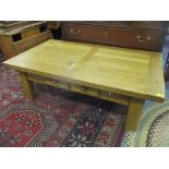 A modern light oak coffee table having two inset drawers and on block shaped legs, 45cm h x 140cm w,