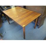 A vintage Danish teak extending dining table by Korup Stolefoabrik Mobler having one extra leaf