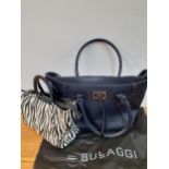 Bulaggi- Two modern bags, one in a zebra print with black resin handles and red interior having 2