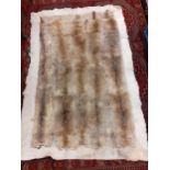 A Retro wolf and other animal fur and hide patchwork rug, 44" x 64" Condition: Some wear and
