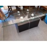 A contemporary black ash cube and brushed chrome coffee table with a larger glass top, 370cm x 120cm