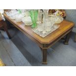 A reproduction American walnut coffee table having X-framed stretcher and fluted legs 41cm h x 150cm