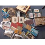 A quantity of early to late 20th century postcards, a Victorian photo album and contents, a