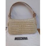 Moschino-A vintage cream patent leather crocodile effect (domestic skin) handbag with silver tone