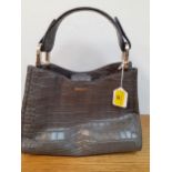 DKNY- A grey leather crocodile effect handbag with silver tone hardware, branded keyring disc and