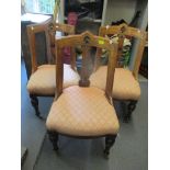 Three Victorian walnut chairs having pierced splat backs with motif to the centre, on fluted