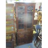 An Edwardian mahogany bookcase having a dental moulded cornice, two glazed doors, two drawers and